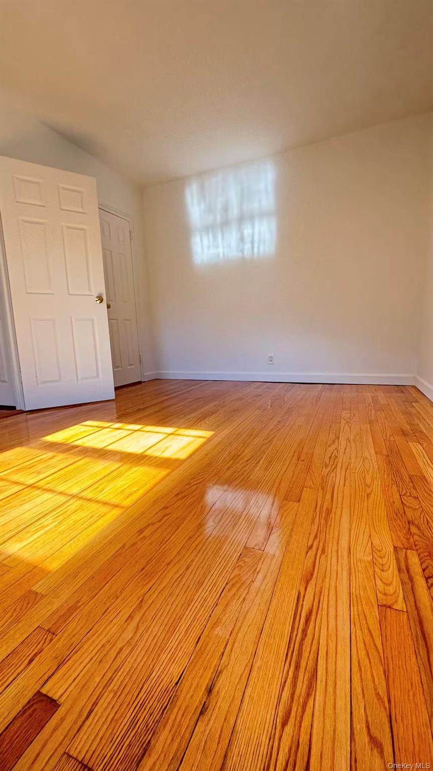 13806 78th Avenue, Unit 37D Queens, NY 11367 - Photo 5 of 11 a view of empty room with wooden floor and fan