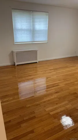 a view of a room with wooden floor