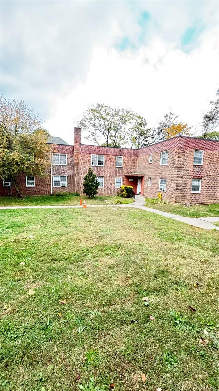 13806 78th Avenue, Unit 37D Queens, NY 11367 - Photo 9 of 11 a view of a building with a big yard and large trees
