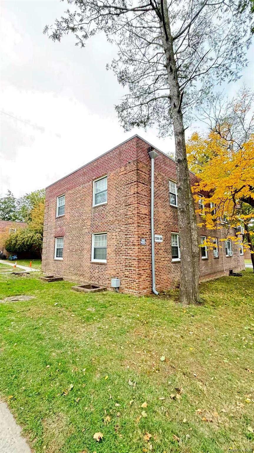 13806 78th Avenue, Unit 37D Queens, NY 11367 - Photo 10 of 11 a large house with a big yard and large trees