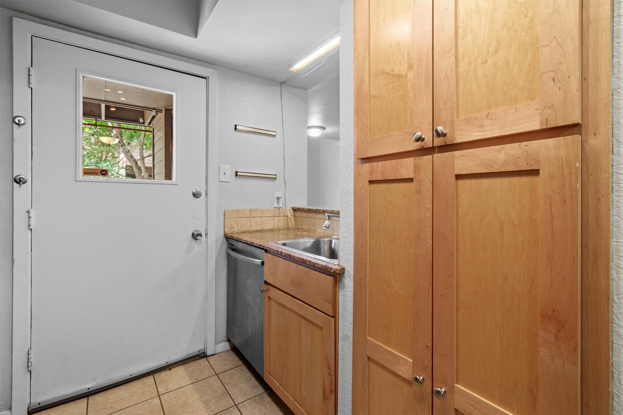 3627 Menchaca Road, Unit 204 Austin, TX 78704 - Photo 8 of 23 A compact kitchen area features ample cabinetry and practical amenities.