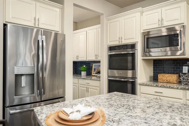 a kitchen with granite countertop stainless steel appliances and granite counter tops