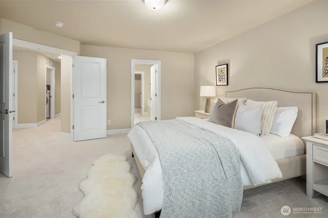 a spacious bedroom with a bed and a lamp