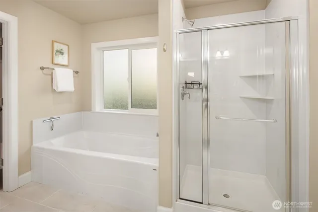 a bathroom with a bathtub and a shower