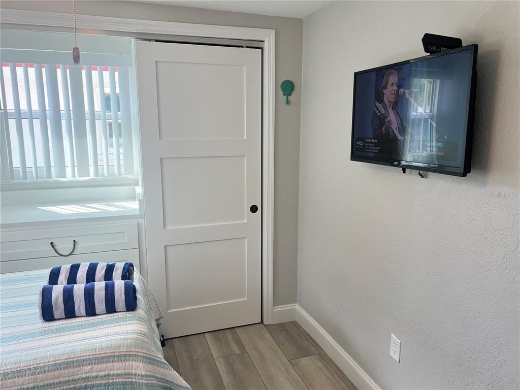 6154 Midnight Pass Road, Unit D02 Sarasota, FL 34242 - Photo 11 of 12 a bedroom with a bed and a window