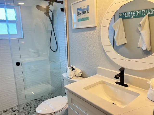 a bathroom with a sink toilet and shower