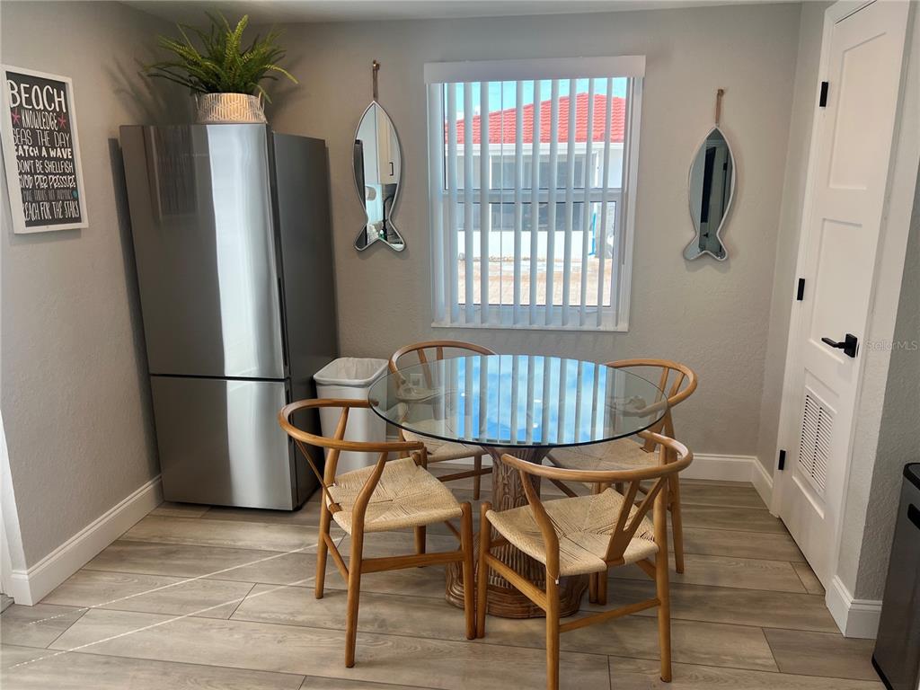6154 Midnight Pass Road, Unit D02 Sarasota, FL 34242 - Photo 3 of 12 a dining room with furniture and window