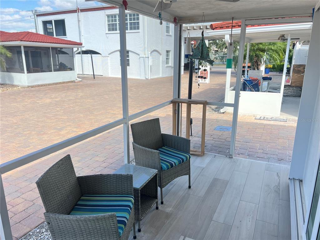 6154 Midnight Pass Road, Unit D02 Sarasota, FL 34242 - Photo 6 of 12 a view of a chairs and tables in the balcony