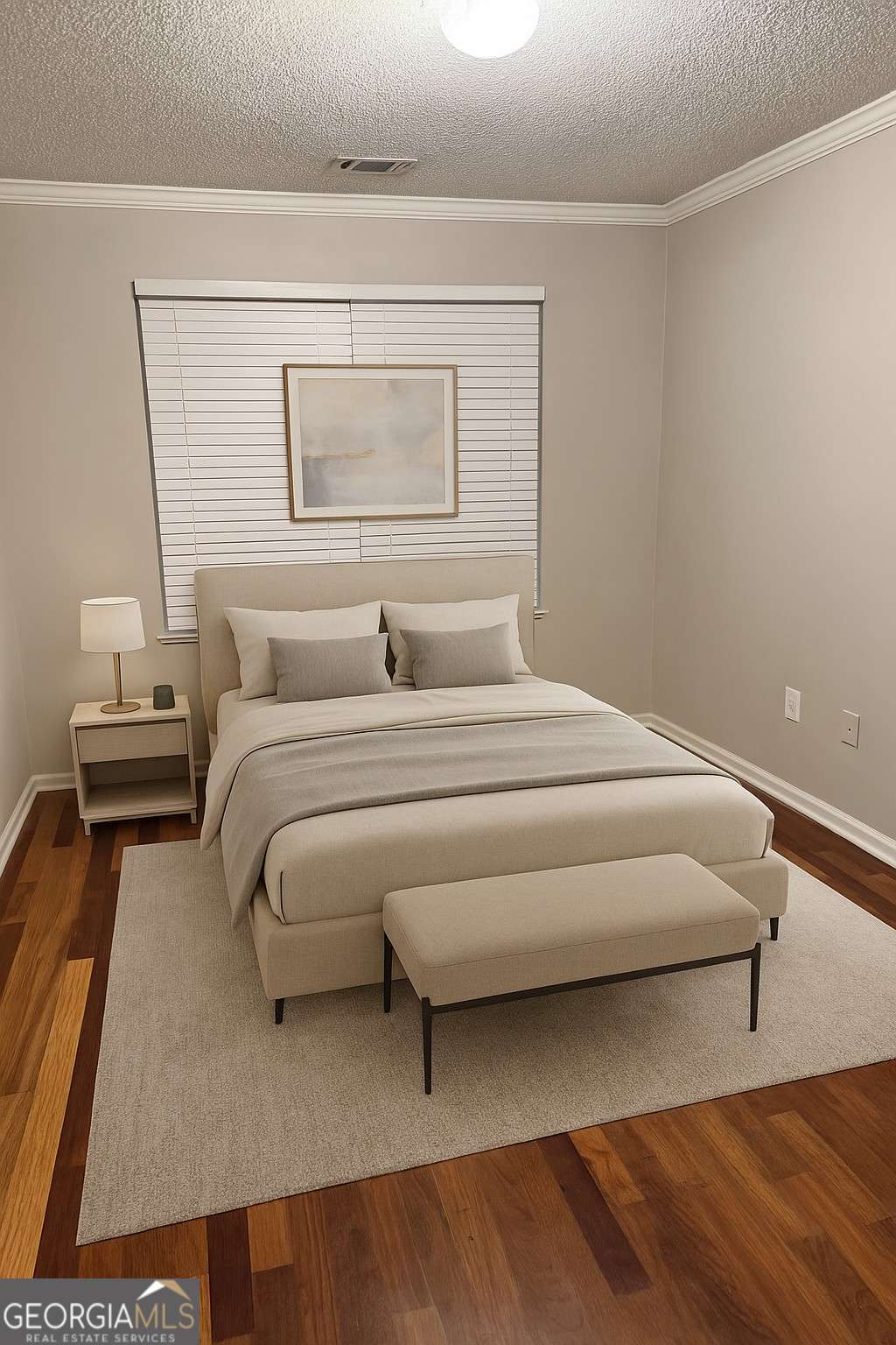 a bedroom with a bed and a potted plant on dresser