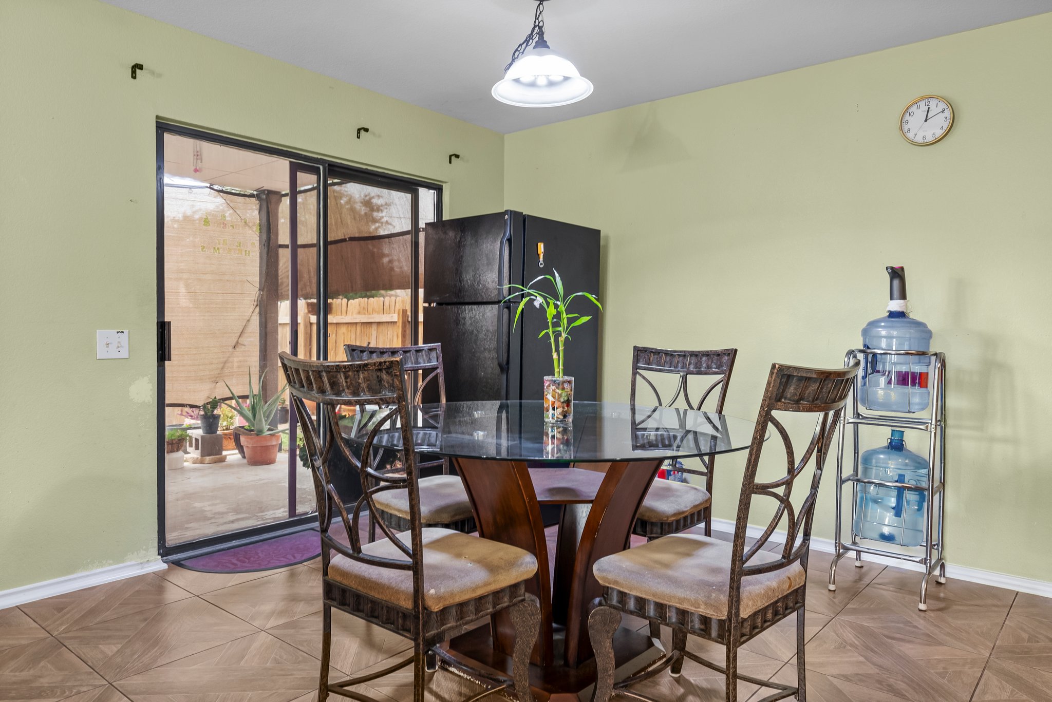 6829 Walkup Lane Austin, TX 78747 - Photo 6 of 18 The compact dining area offers a glass-top table, tile flooring, and direct outdoor access through sliding doors.