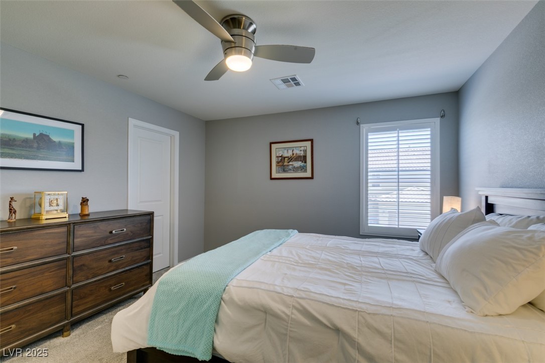 2870 Turnstone Ridge Street Henderson, NV 89044 - Photo 33 of 50 Bedroom featuring a ceiling fan and light carpet