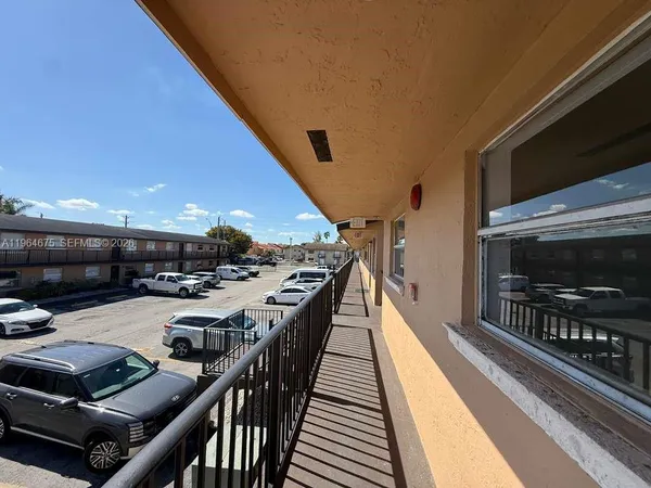 a view of a patio with table and chairs with wooden floor and fence