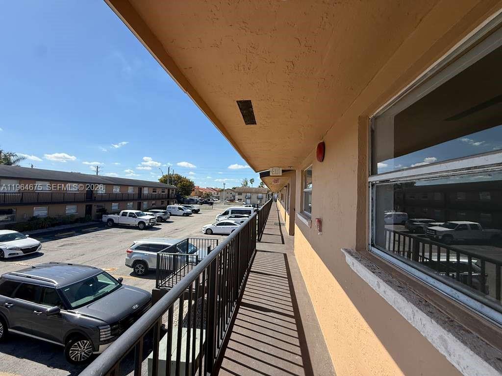 5491 West 24th Avenue, Unit 39 Hialeah, FL 33016 - Photo 3 of 12 a view of a patio with table and chairs with wooden floor and fence