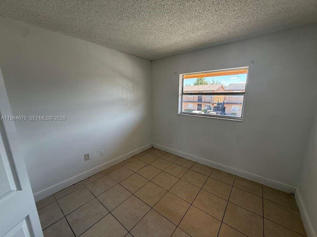 5491 West 24th Avenue, Unit 39 Hialeah, FL 33016 - Photo 4 of 12 an empty room with a window