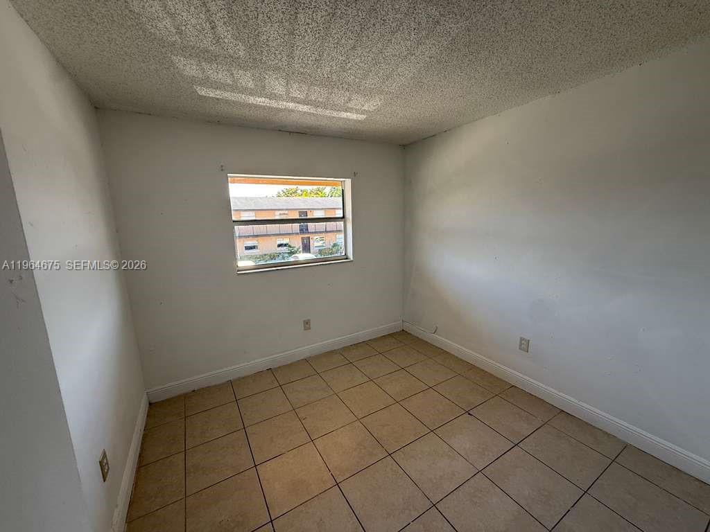 5491 West 24th Avenue, Unit 39 Hialeah, FL 33016 - Photo 5 of 12 a view of an empty room and window