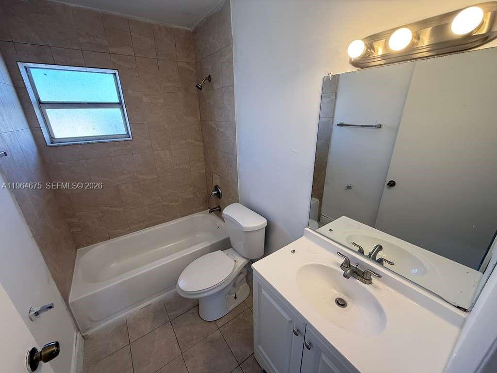 5491 West 24th Avenue, Unit 39 Hialeah, FL 33016 - Photo 7 of 12 a bathroom with a sink a toilet and shower