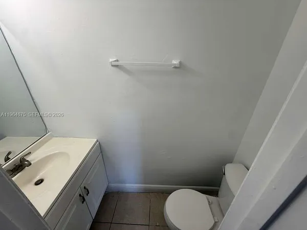 a bathroom with a sink a toilet and vanity