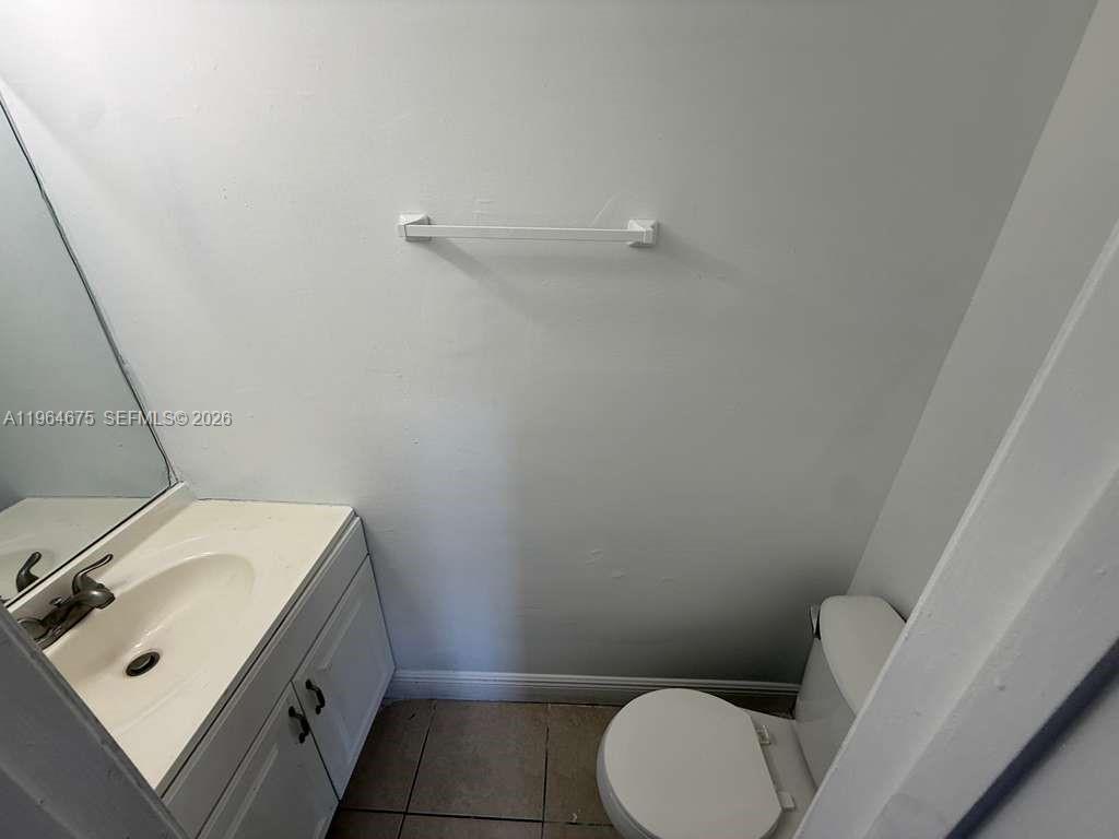 5491 West 24th Avenue, Unit 39 Hialeah, FL 33016 - Photo 9 of 12 a bathroom with a sink a toilet and vanity