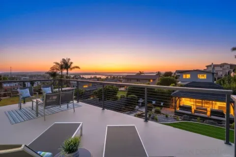 a view of a patio with a table and chairs under an umbrella
