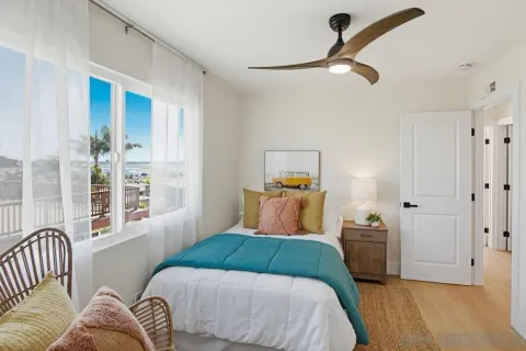 a bedroom with a bed and wooden floor