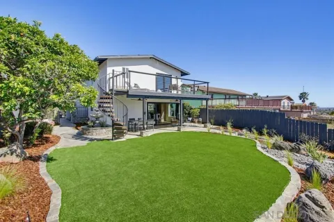 a view of a house with swimming pool and sitting area