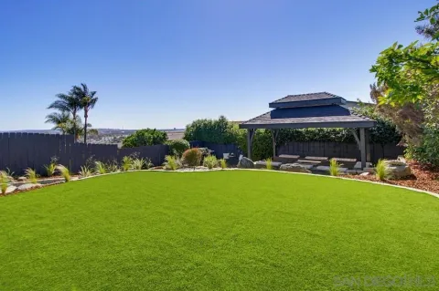 a view of a swimming pool and lounge chairs