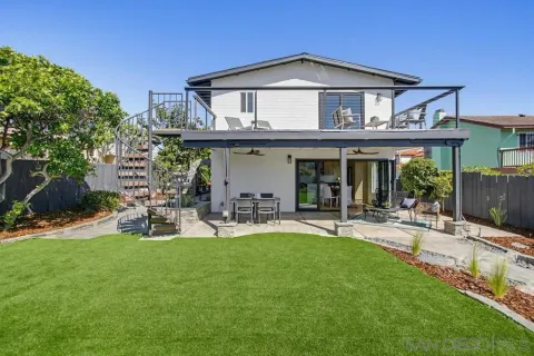 a front view of a house with patio and garden