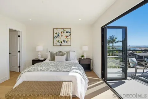 a bedroom with a large bed and a chandelier