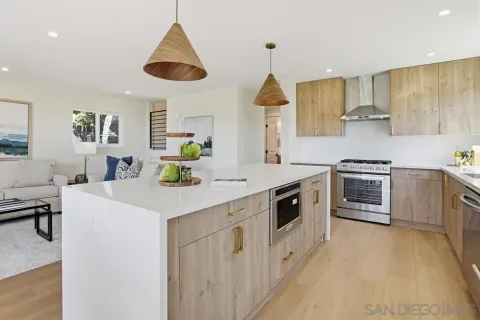 a kitchen with stainless steel appliances kitchen island a cabinets and wooden floor