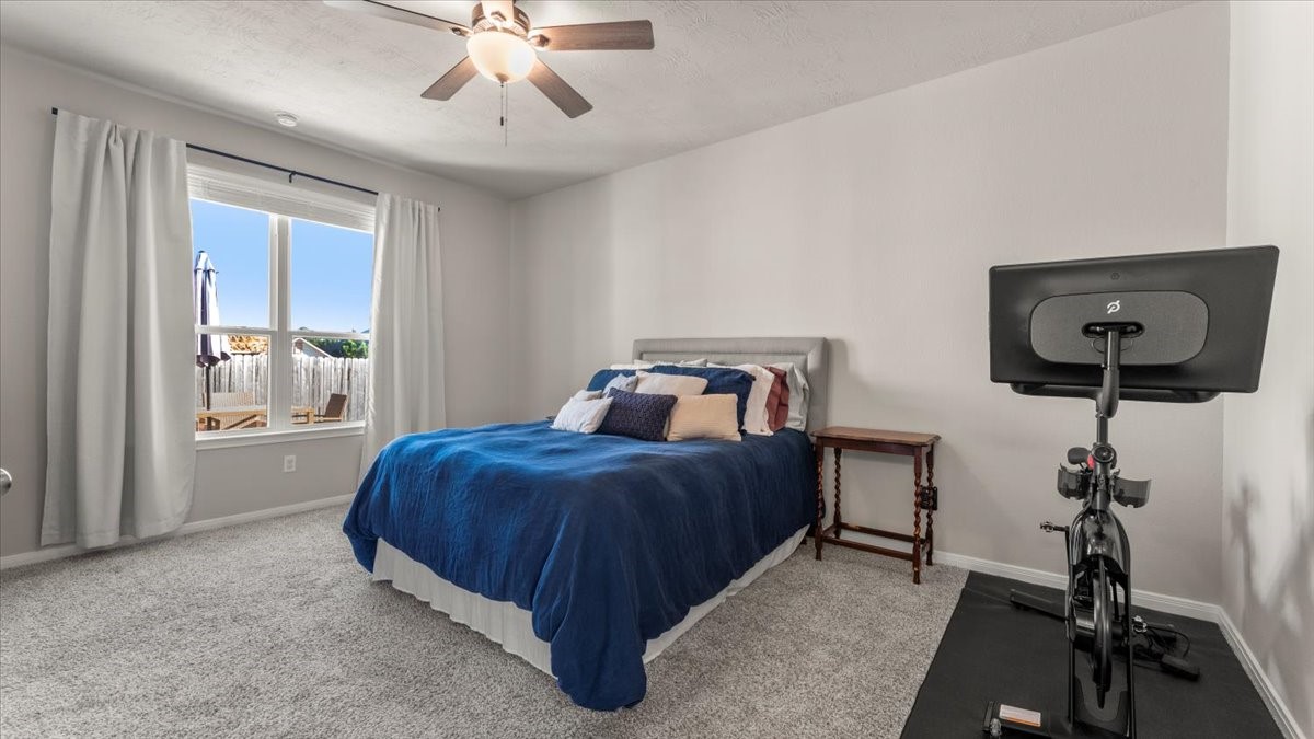 103 Rudder Way Huntsville, TX 77320 - Photo 14 of 35 a bedroom with a bed and a chandelier