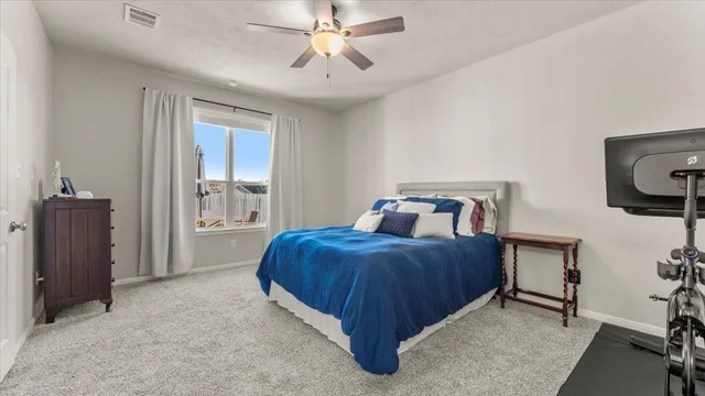 a bedroom with a bed and a chandelier