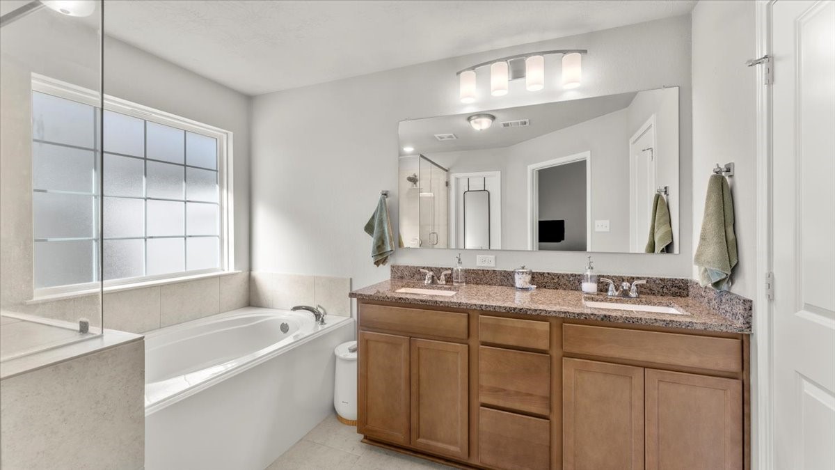 103 Rudder Way Huntsville, TX 77320 - Photo 17 of 35 a bathroom with a tub sink and mirror