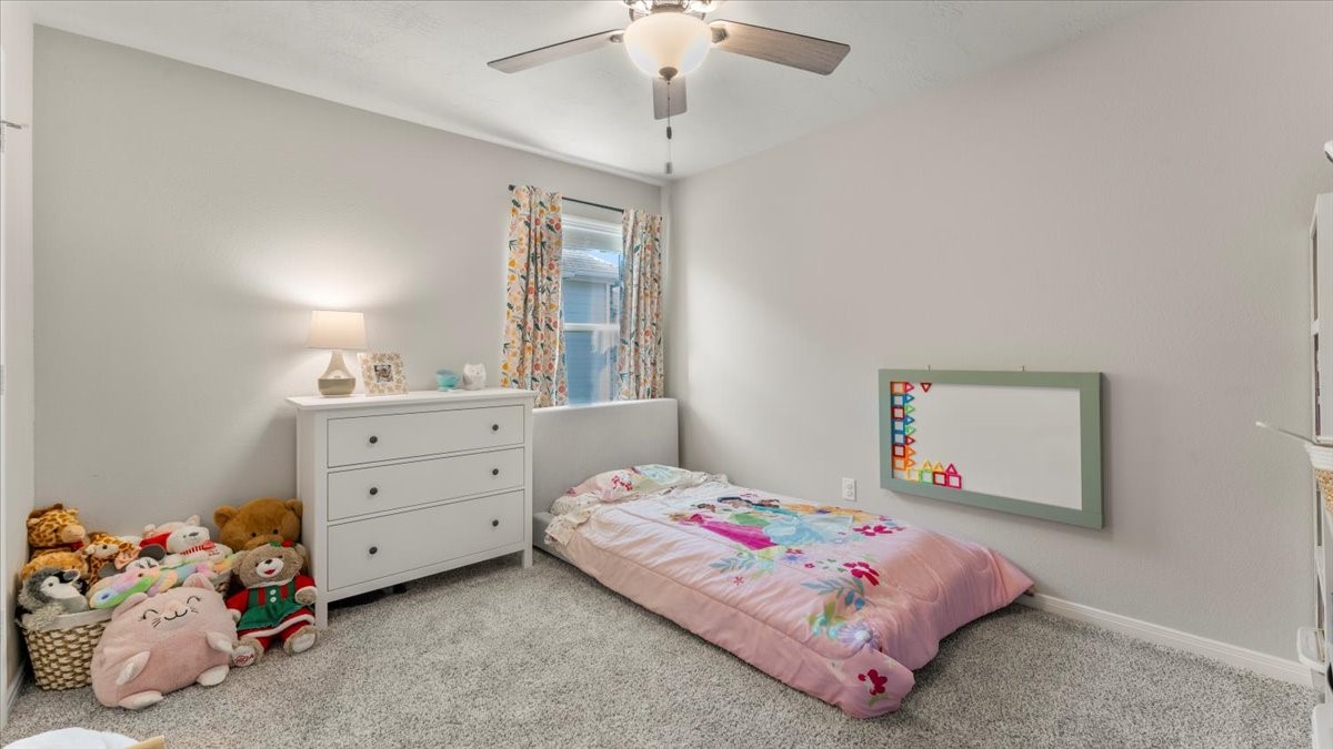 103 Rudder Way Huntsville, TX 77320 - Photo 21 of 35 a bedroom with a bed and a dresser