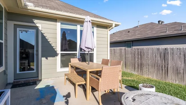 a view of a porch with furniture and a yard