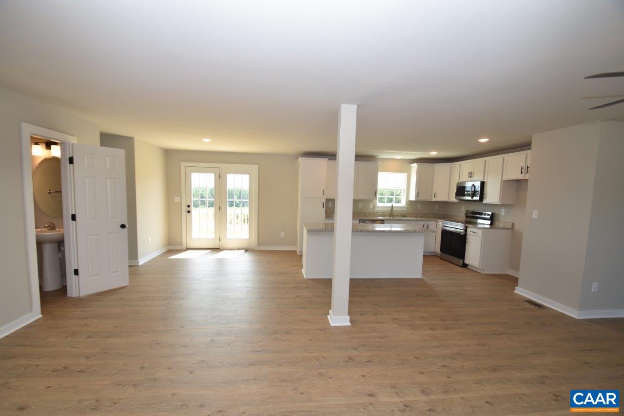 4305 Cedar Lane Road Kents Store, VA 23084 - Photo 17 of 27 a view of a kitchen with refrigerator and wooden floor