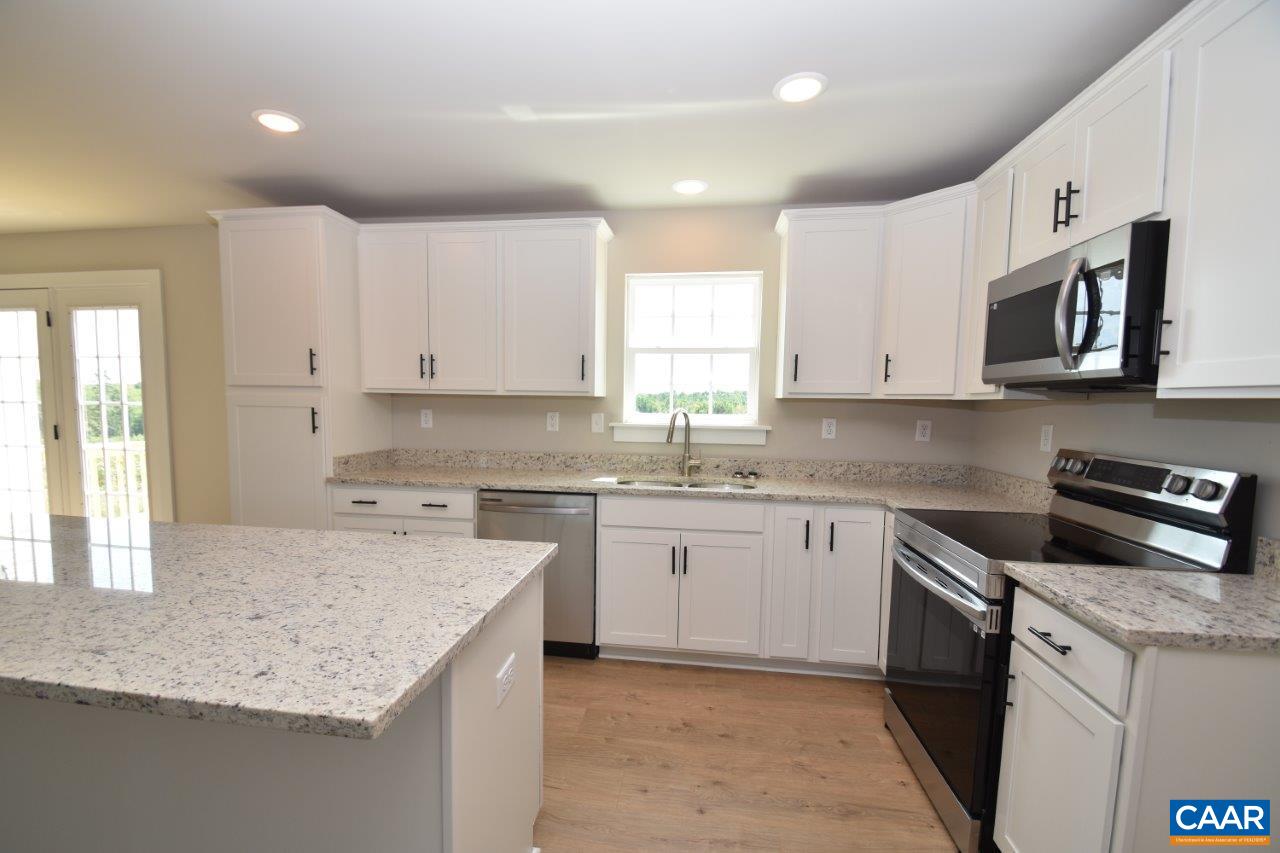 4305 Cedar Lane Road Kents Store, VA 23084 - Photo 23 of 27 a kitchen with granite countertop cabinets stainless steel appliances a sink and a window
