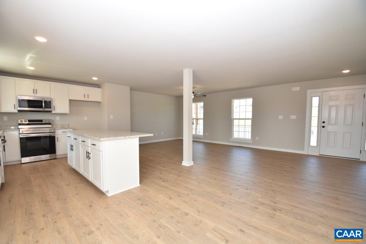 4305 Cedar Lane Road Kents Store, VA 23084 - Photo 27 of 27 a large kitchen with stainless steel appliances granite countertop a stove a sink and a refrigerator