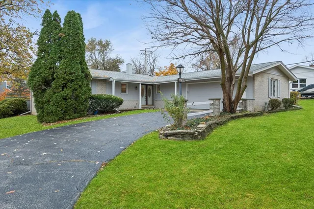 a front view of a house with a yard and porch
