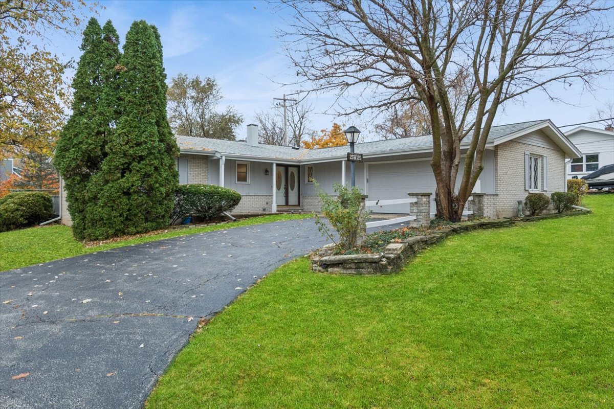 a front view of a house with a yard and porch