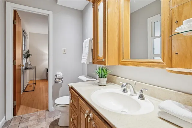 a bathroom with a sink a toilet and a mirror