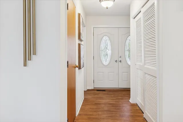 a view of a hallway with wooden floor