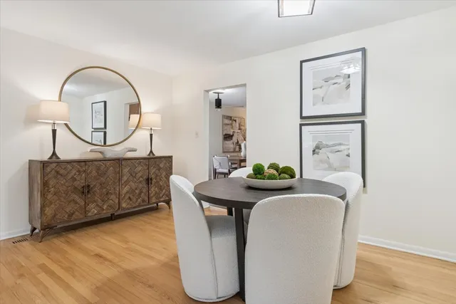 a living room with furniture and a mirror