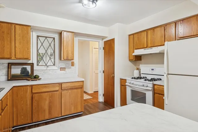 a kitchen with a stove a sink and a refrigerator