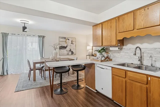 a kitchen with a sink cabinets and wooden floor
