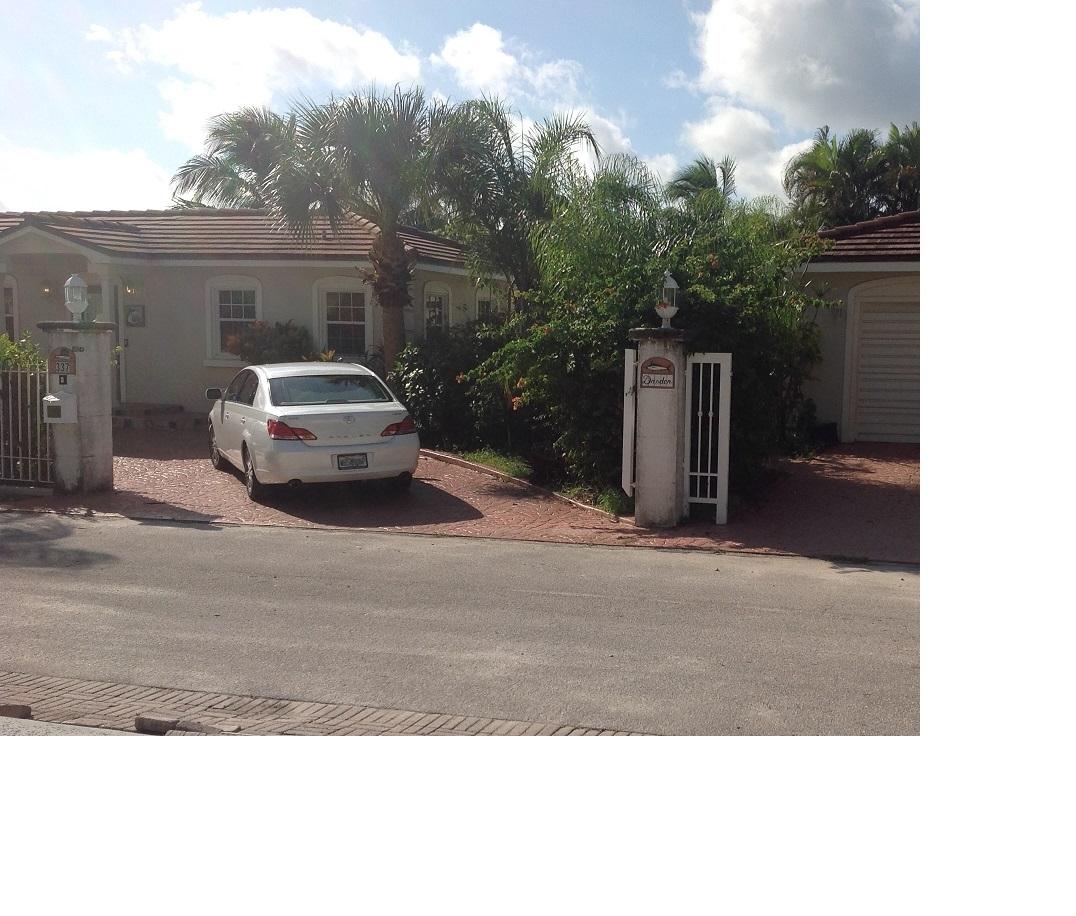 337 East 25th Street Riviera Beach, FL 33404 - Photo 6 of 7 a car parked in front of white house