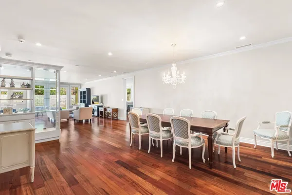 a view of a dining room with furniture wooden floor and chandelier
