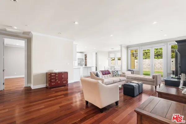 a living room with furniture or wooden floor and a large window