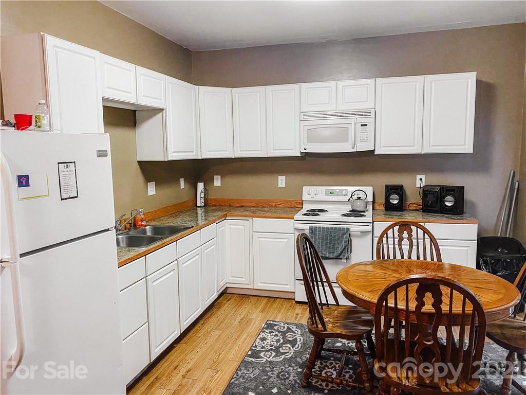 7345 Pop Basinger Road Salisbury, NC 28146 - Photo 36 of 38 a kitchen with stainless steel appliances a stove a sink refrigerator and a microwave