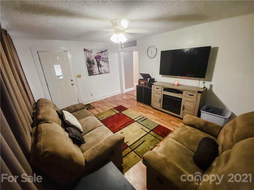 7345 Pop Basinger Road Salisbury, NC 28146 - Photo 8 of 38 a living room with furniture and a flat screen tv