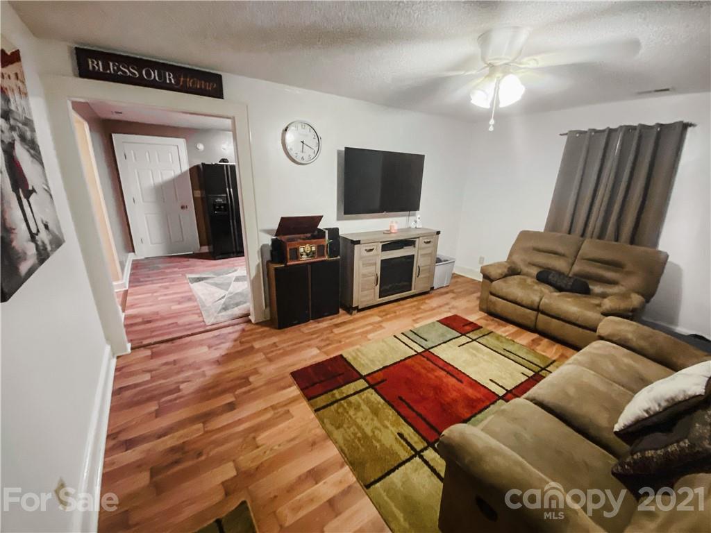 7345 Pop Basinger Road Salisbury, NC 28146 - Photo 10 of 38 a living room with furniture and a flat screen tv